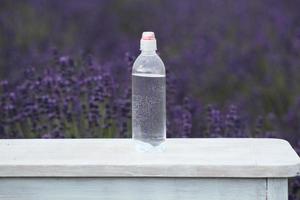 Hand holding a bottle of water photo