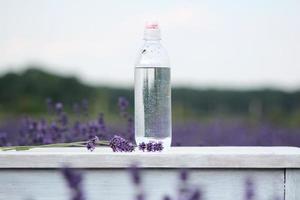 Hand holding a bottle of water photo