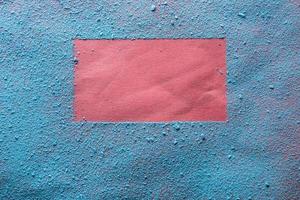Imprint of a bright red frame on blue powder. Copy space. Abstract background. Top view. photo