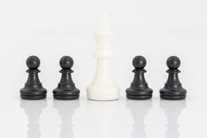 Black and white chess pieces on white background photo