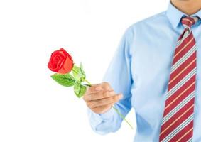 Man holding red rose in hand on white photo