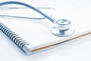 Stethoscope on blank notepad photo