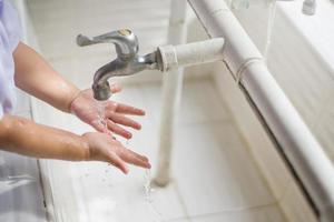 Child washing hand for virus protection photo