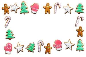Handmade festive gingerbread cookies in the form of stars, snowflakes, people, socks, staff, mittens, Christmas trees, hearts for xmas and new year holiday on white paper background photo