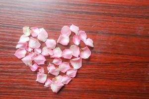 A heart shape made of pink petals photo