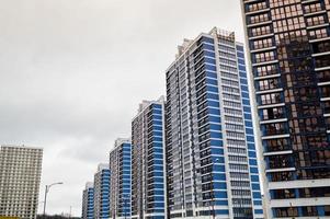 New modern tall blue glass multi-storey comfortable urban monolithic frame houses buildings skyscrapers new buildings in the big city of the megalopolis photo