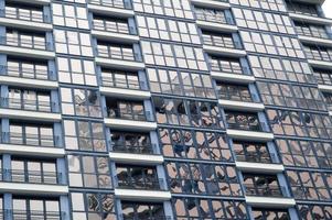 Beautiful modern blue glass fiberglass windows of the facade wall of a modern skyscraper building house. Background, texture photo