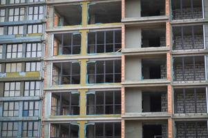 Windows and accessories of a new modern monolithic frame-block house under construction with windows, walls and balconies. Background, texture photo