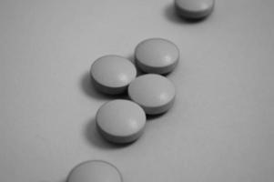 Medicamentos farmacéuticos médicos redondos en blanco y negro para el tratamiento de enfermedades y la eliminación de microbios y pastillas de virus y medicamentos vitamínicos para el coronavirus. el fondo foto