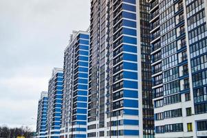 New modern tall blue glass multi-storey comfortable urban monolithic frame houses buildings skyscrapers new buildings in the big city of the megalopolis photo