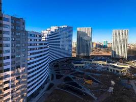 View of the new beautiful residential complex from new buildings with buildings houses monolithic concrete frame panel multi-story skyscrapers of the big city of the metropolis photo