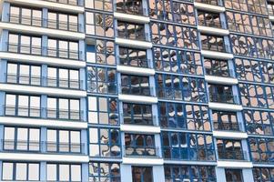 Beautiful modern blue glass fiberglass windows of the facade wall of a modern skyscraper building house. Background, texture photo