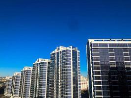 View of the new beautiful residential complex from new buildings with buildings houses monolithic concrete frame panel multi-story skyscrapers of the big city of the metropolis photo