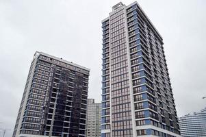 New modern tall blue glass multi-storey comfortable urban monolithic frame houses buildings skyscrapers new buildings in the big city of the megalopolis photo