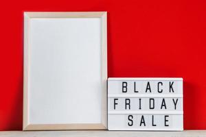 Black Friday concept. Sign and empty frame on red background. photo