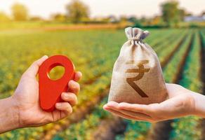Hands with location pin and indian rupee money bag. Land market. Estimation cost of plots. Agriculture agribusiness. Transport and construction industry. Buying and selling land. photo