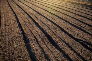 Soil after cultivation, mixing and grinding a field. Cultivated farm land in fall, preparing the soil for cutting rows for the next season. Softening and grinding, loosening the earth. Farming photo