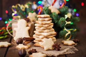 Christmas cookies and tinsel on a wooden background photo