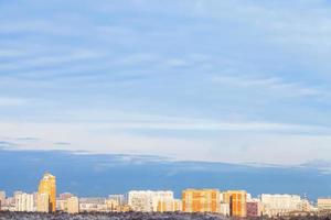 blue sky over town illuminated by evening sun photo