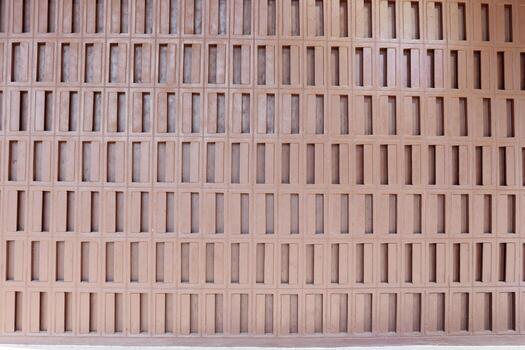 Wall made from concrete in vertical rectangle shape and painted dark brown color. photo