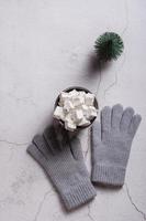 Cocoa with marshmallows, woolen gloves and a Christmas tree on plaster. Top and vertical view. photo
