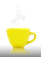 Yellow cup with hot drink  on reflect floor and white background photo