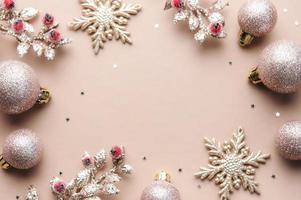 Christmas balls and golden garland on pastel beige background. photo