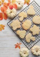 Autumn baking. Cookies in the form of pumpkin and leaves on the table. photo