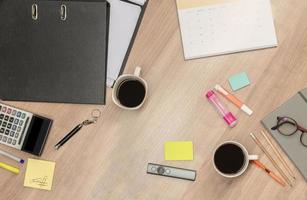 Coffee, files and accessories on table photo