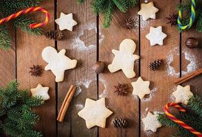 Christmas cookies and tinsel on a wooden background photo