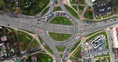 accelerated video 8x aerial view above at crossroads on road junction with heavy traffic in city