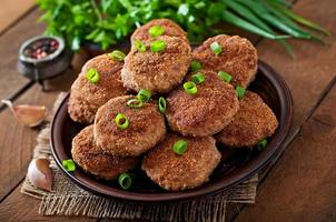 Juicy delicious meat cutlets on a wooden table in a rustic style. photo