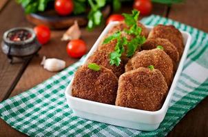 Juicy delicious meat cutlets on a wooden table in a rustic style. photo