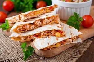 Mexican Quesadilla wrap with chicken, corn and sweet pepper and salsa photo