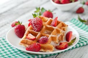 Belgium waffles with strawberries and mint  on white plate photo