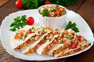 Mexican Quesadilla wrap with chicken, corn and sweet pepper and salsa photo