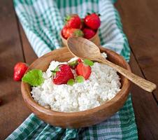 Cottage cheese with strawberries in a wooden bowl photo