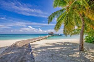 Idyllic tropical beach landscape for background or wallpaper. Wooden pier, paradise island, summer vacation landscape holiday destination concept. Exotic island, relaxing view. Paradise seaside lagoon photo