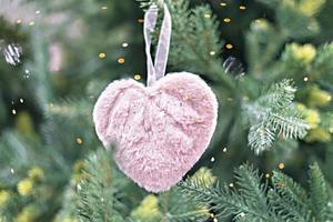 Christmas tree with pink fluffy soft heart in bokeh light decoration holiday decorations New year concept merry Christmas background greeting card photo