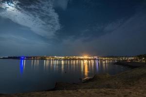 colorful light in the sea from a resort in egypt photo