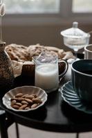 Aesthetic breakfast. Milk coffee, milk tea, sugar, almond, almond cakes, biscuits, marzipans and puffs. British breakfast in a cozy home. Autumn mood. photo