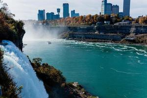 Niagara Falls from the American and Canadian sides. Rainbow over the waterfall. The most popular tourist place. Stormy river that flows into the lake. photo