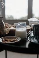 Aesthetic breakfast. Milk coffee, milk tea, sugar, almond, almond cakes, biscuits, marzipans and puffs. British breakfast in a cozy home. Autumn mood. photo