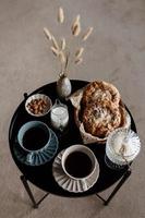 Aesthetic breakfast. Milk coffee, milk tea, sugar, almond, almond cakes, biscuits, marzipans and puffs. British breakfast in a cozy home. Autumn mood. photo