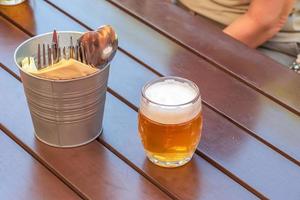 Glass of light beer on the wooden table. photo