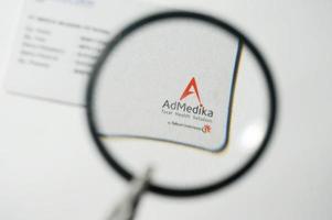 Admedika Card under magnifying glass with Selective Focus photo