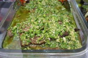 Dendeng balado is a typical cuisine of West Sumatra made from thin and wide slices of beef that are dried and then fried dry, With Selctive Focus photo