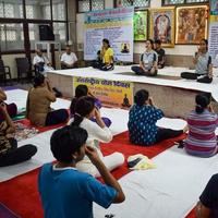 New Delhi, India, June 19 2022 -Group Yoga exercise session for people of different age groups in Balaji Temple, Vivek Vihar, International Yoga Day, Big group of adults attending yoga class in temple photo