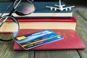 Credit card put on passport on wooden desk photo