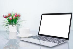 Laptop mockup and coffee cup with flower photo